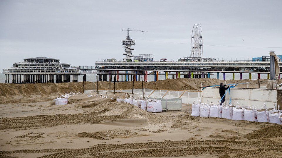 Toen storm Eunice in 2022 over Nederland trok, werden bij strandtenten in Scheveningen zandzakken geplaatst.