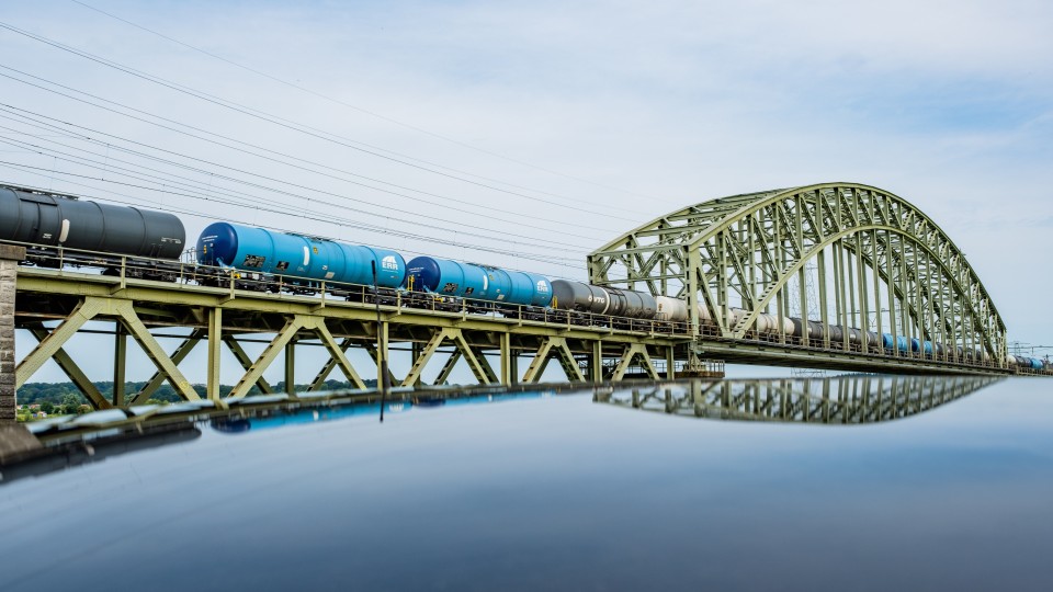 Een goederentrein rijdt over Spoorviaduct Oosterbeek over de Nederrijn.
