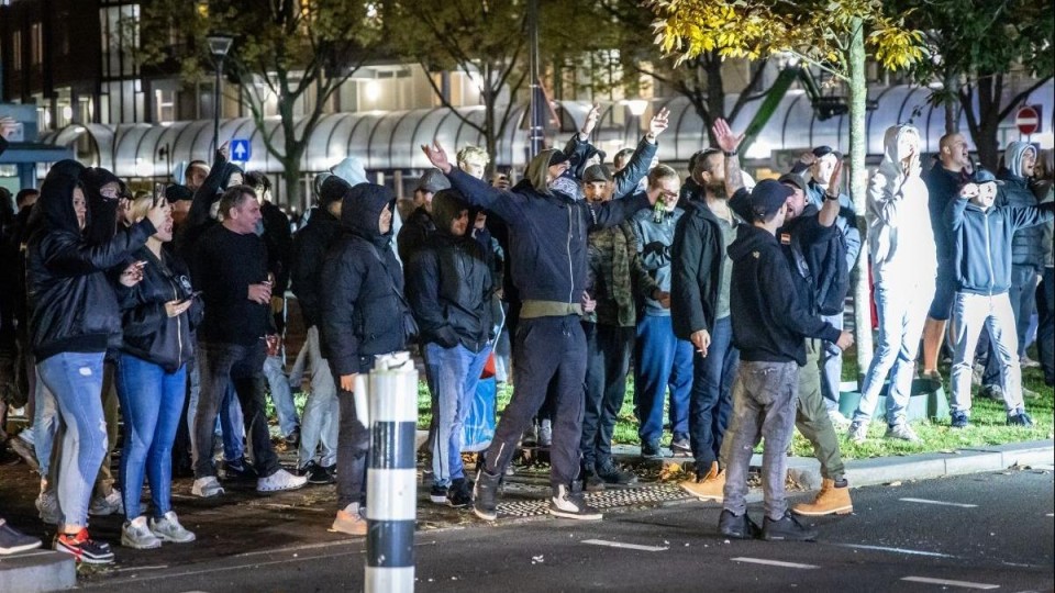 in het zwart geklede jongens staan te schreeuwen op straat
