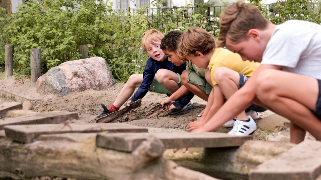 Kinderen spelen op groenblauw schoolplein