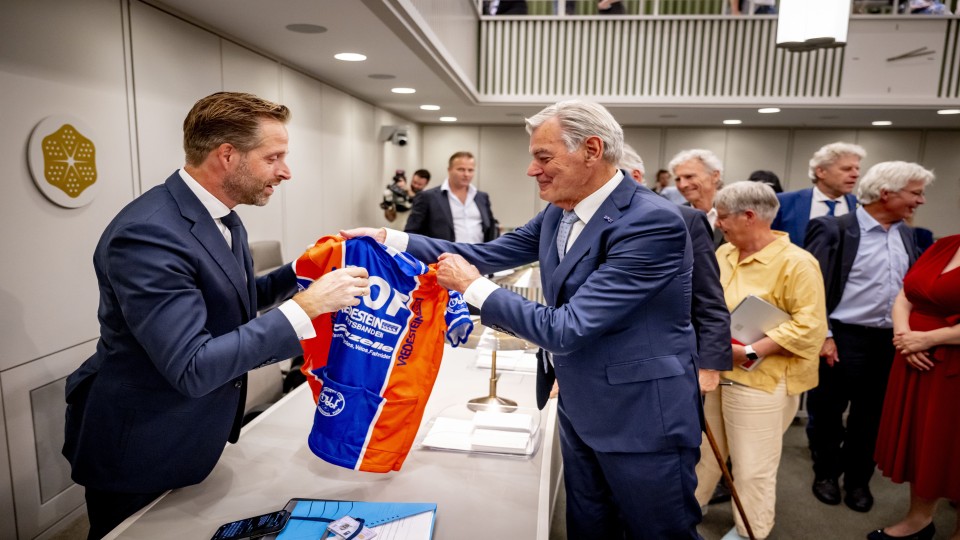 Demissionair minister Hugo de Jonge kreeg dinsdagmiddag van 50Plus-senator Martin van Rooijen een shirt van wielerclub Door Oefening Flink,…